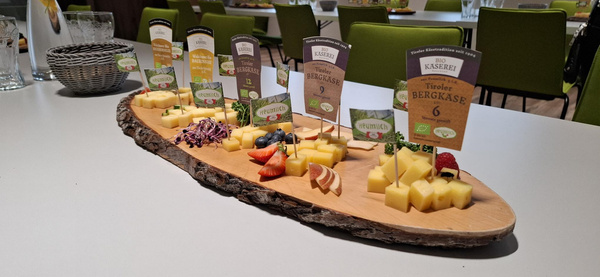 KI generiert: Hauptinhalt: Käse- und Wurstplatte mit Beilagen.
